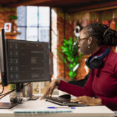Programmer solving tasks with AI LLM chatbot answering prompts using predictive technology. Startup company worker using computer to interact with large language model program
